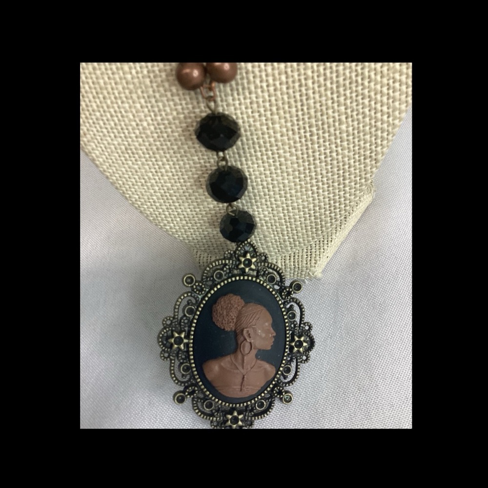 Brown and black cameo necklace.